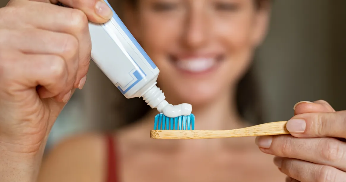 Woman brushing teeth while practicing intermittent fasting with oral hygiene routine