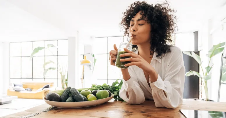 Woman enjoying plant-based whole foods diet with intermittent fasting for sustainable weight loss wellness