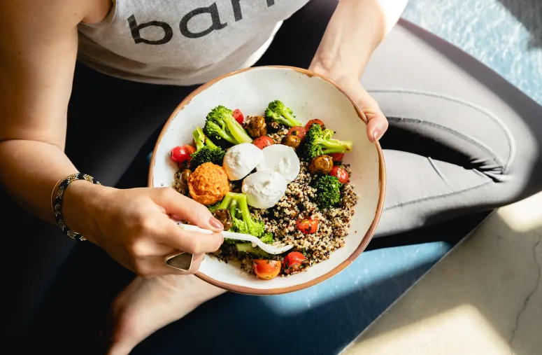 Woman contemplating healthy lifestyle with intermittent fasting for wellness and weight management goals