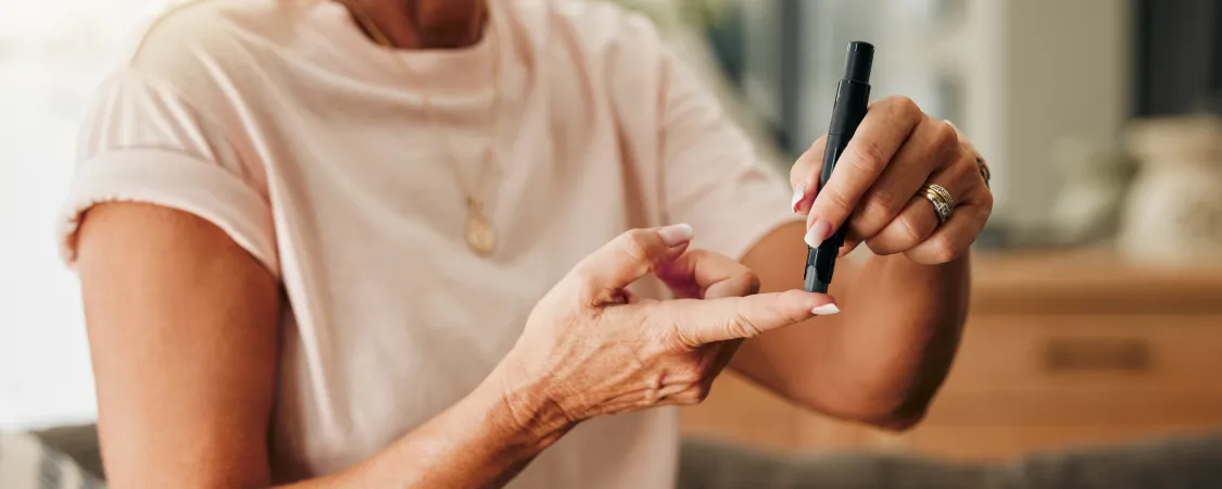 Person with diabetes monitoring blood sugar levels while practicing intermittent fasting for safe weight management