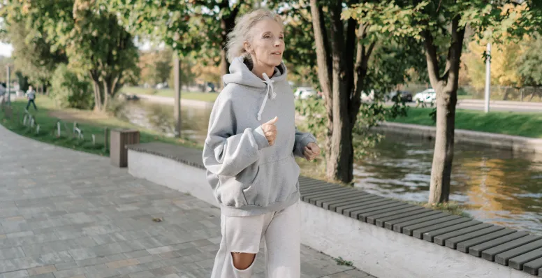 Active woman over 50 running showing health benefits of intermittent fasting