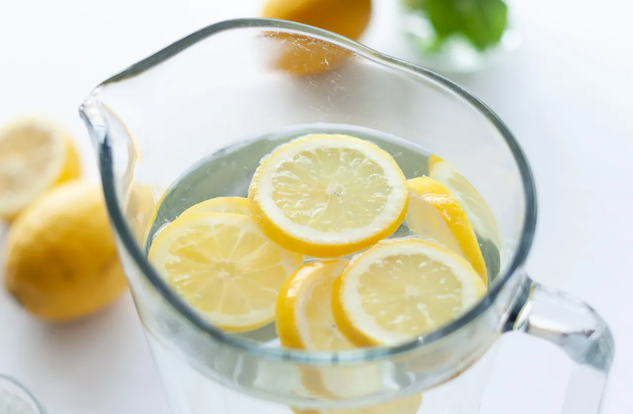 Fresh lemon slices in water glass for intermittent fasting hydration