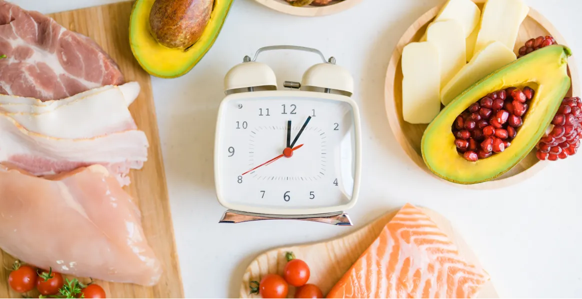 Low-carb intermittent fasting meal planning combining healthy foods with strategic eating windows for weight loss and metabolic health